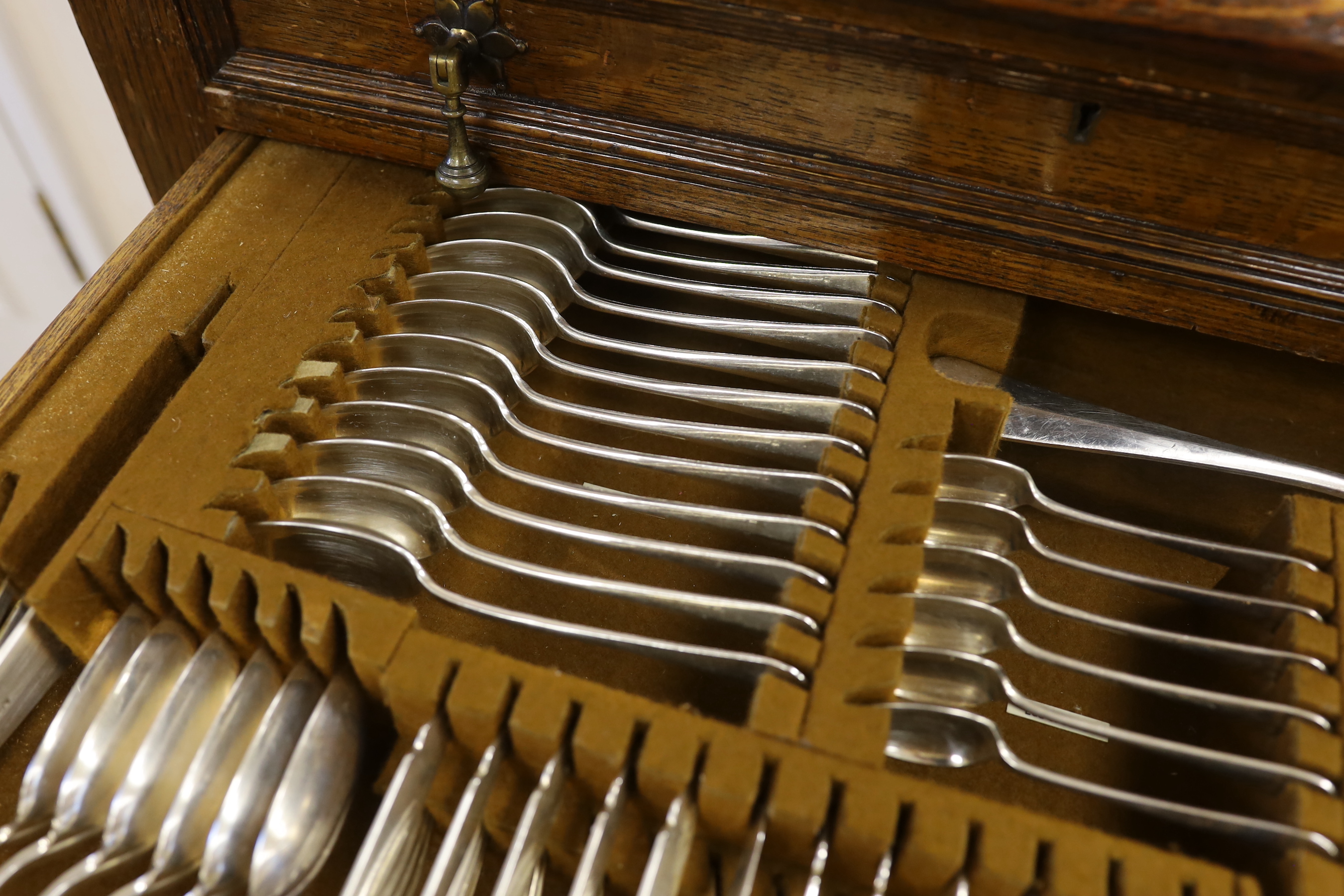 An oak standing canteen with two drawers of Mappin and Webb silver plated cutlery, settings for twelve people, 78cm high x 70cm wide x 54cm deep